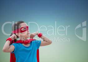 Girl in superhero costume showing fists against blue background