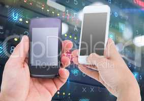 Hands holding mobile phone against server storage system in background
