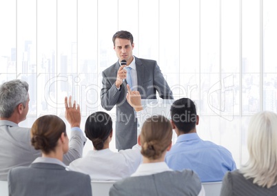 Businessman speaking through microphone during seminar