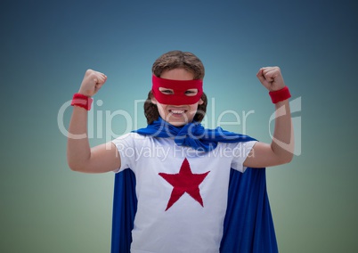 Boy in superhero costume showing fists against blue background