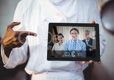 Businessman having video call with colleagues on digital tablet