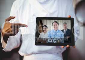 Businessman having video call with colleagues on digital tablet