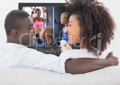 Smiling couple watching a sports in television
