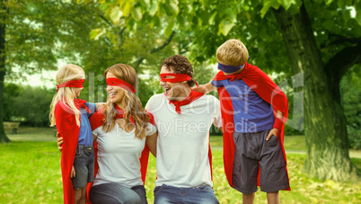 Family in superhero costume in park
