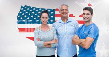 Young man and woman with senior man standing against American flag