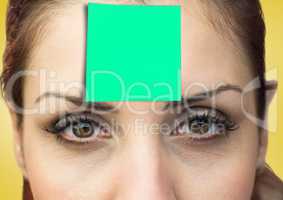 Woman with green sticky note on her forehead