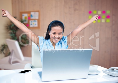 Businesswoman celebrating on the desk