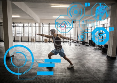 Fit man exercising in gym with  futuristic interface