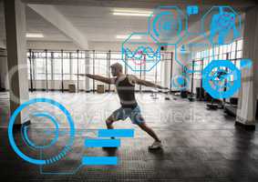 Fit man exercising in gym with  futuristic interface
