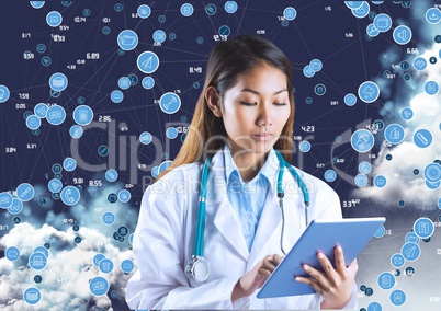 Female doctor with stethoscope using digital tablet