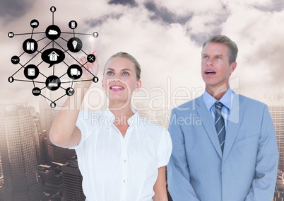 Businesspeople using digital screen with digitally generated icon