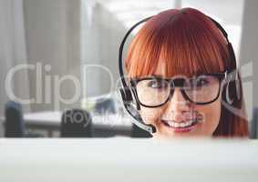 Portrait of a woman talking on headset in customer service office