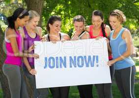 Group of happy women holding placard with text join now