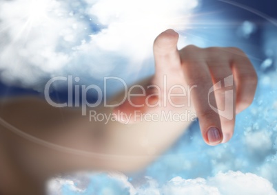 Hand pointing against cloudy sky in background