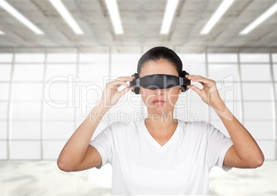 Digital composite image of woman using virtual reality glasses