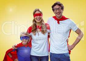 Portrait of parents and kids wearing red cape and mask standing with arm around