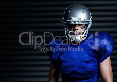 American football player standing against grey background