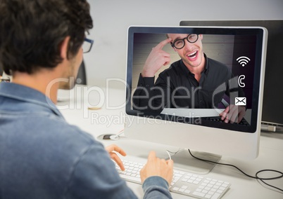 Man having a video call with his friend on desktop pc