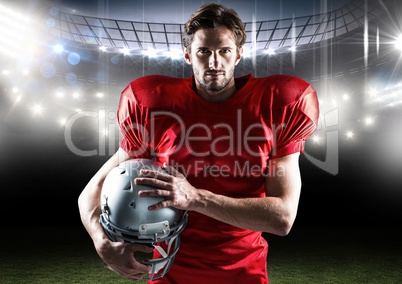 Portrait of american player standing with helmet in stadium