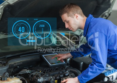 Mechanic using digital tablet while working against car mechanics interface in background