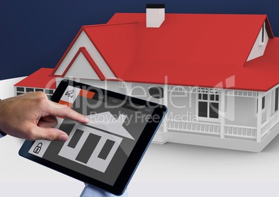 Hands using digital tablet with home security icons