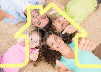 Family laying on the rug at home against house outline in background