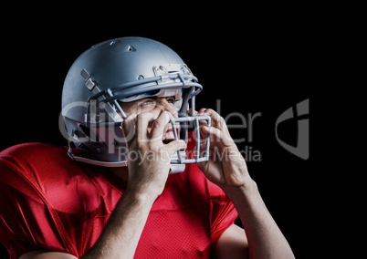 Aggressive american football player holding his helmet