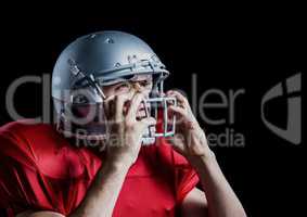 Aggressive american football player holding his helmet