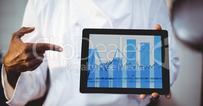 Man showing digital tablet displaying graph chart on screen