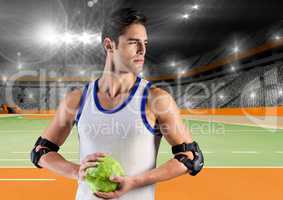 Male handball player holding ball at handball court