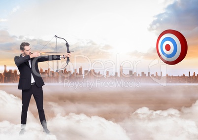 Businessman holding bow and arrow while aiming  at the target board