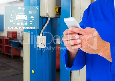 Mechanic using smartphone in garage with car mechanic interface