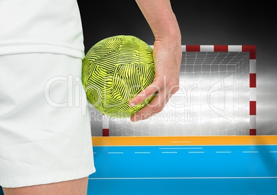 Player holding a handball near goal in stadium