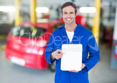 Mechanic holding clipboard in repair garage