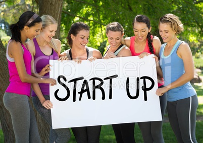 Fit healthy women holding placard that reads start up