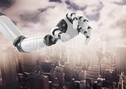 Robot hand over cityscape against cloudy sky