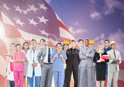 Group of businesspeople standing together against american flag and cloudy sky in background