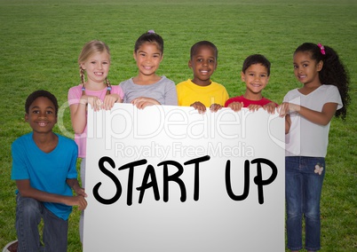 Portrait of kids standing with placard with start up text