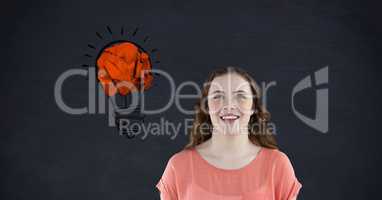 Woman smiling against crumpled paper forming light bulb