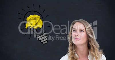 Thoughtful woman with crumpled paper on light bulb shape against black background