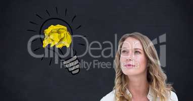 Thoughtful woman with crumpled paper on light bulb shape against black background