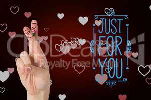 Smiling finger couple with valentines message against red background