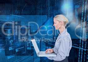 Businesswoman using laptop against binary codes in blue background