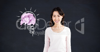 Woman standing next to light bulb with crumpled paper