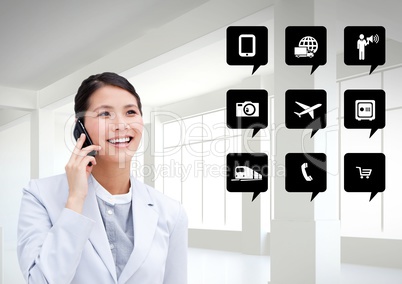 Businesswoman talking on mobile phone next to application icons