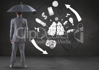 Businessman standing with umbrella against connecting and communication icons