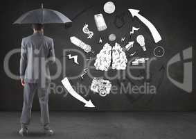 Businessman standing with umbrella against connecting and communication icons