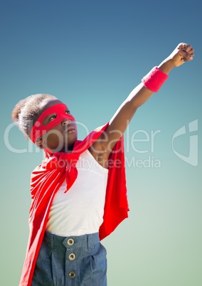 Kid in red cape and mask standing with fist