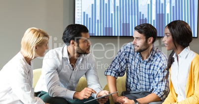 Business people discussing over digital tablet