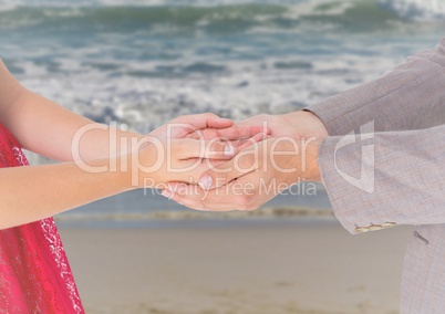 Couple holding hands on beach